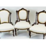 THREE LATE VICTORIAN WALNUT NURSING CHAIRS, similarly upholstered on turned fluted legs with ceramic