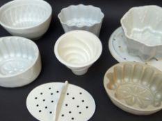 ASSORTED VINTAGE WHITE GLAZED POTTERY JELLY MOULDS & TWO DRAINERS