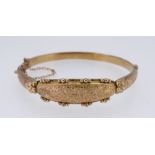 9CT YELLOW GOLD FLORALLY ENGRAVED LADIES BANGLE, 7.6gms, internal diameter size when closed is 60mm