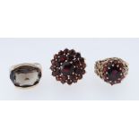 TWO 9CT YELLOW GOLD GARNET SET DRESS RINGS TOGETHER WITH 9ct gold smoky quartz ring, 15.1gms (3)
