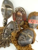 FIVE VARIOUS DAN MASKS some with fibre assemblages (5)