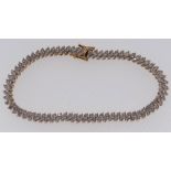 9CT GOLD LADIES BRACELET SET WITH A TWIN ROW OF DIAMOND CHIPS, 19.5cms long, 10.1gms