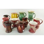 ASSORTED EWENNY POTTERY JUGS all with pinched spouts, various colours (11)