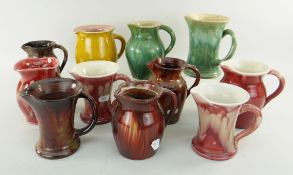 ASSORTED EWENNY POTTERY JUGS all with pinched spouts, various colours (11)