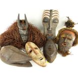 SIX VARIOUS AFRICAN MASKS including Songye Kifwebe mask, Guro antelope with raffia fringe, Lele mask