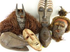 SIX VARIOUS AFRICAN MASKS including Songye Kifwebe mask, Guro antelope with raffia fringe, Lele mask