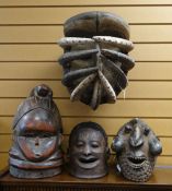 FOUR AFRICAN 'HELMET' MASKS including Wum mask, Mende bundu society mask, Makonde mask and Bete