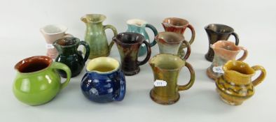 ASSORTED EWENNY SMALL JUGS, including a green jug by HORACE ELLIOTT, stamped with fleur de lis mark