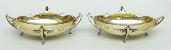 PAIR OF EDWARD VII SILVER OVAL BON BON DISHES, having four whiplash handles terminating in hoof