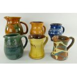 ASSORTED EWENNY POTTERY JUGS mostly inscribed including 'Llaeth, dwfr da rhod duw' ETC one dated