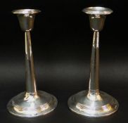 PAIR OF GEORGE V SILVER CIRCULAR TAPERING CANDLESTICKS (loaded), Birmingham 1910 (2).