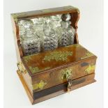 VICTORIAN BRASS BOUND WALNUT BOX TANTALUS, c. 1880, containing three cut glass spirit decanters