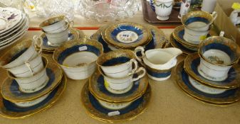 HUGHES & CO BONE CHINA POWDER BLUE GROUND TEA SERVICE FOR TWELVE decorated with Chinese designs (