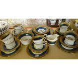 HUGHES & CO BONE CHINA POWDER BLUE GROUND TEA SERVICE FOR TWELVE decorated with Chinese designs (