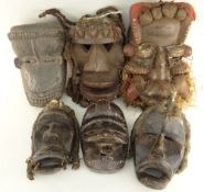 SIX WOBE-GERE MASKS including some with fetish bundles and fibre assemblages (6)