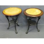 TWO CAST IRON PUB TABLES, reproduction with 59cms diameter mahogany and faux marble effect tops on