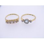 TWO 18CT GOLD DRESS RINGS, one set with central, possibly sky blue topaz, flanked by two small