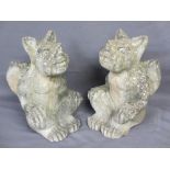 RECONSTITUTED STONE WINGED SEATED GARGOYLES, a pair, 44cms H, 28cms W