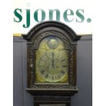 BRASS DIAL CARVED OAK LONGCASE the arched dial top marked 'Tempus Fugit', flanked by dolphin pierced