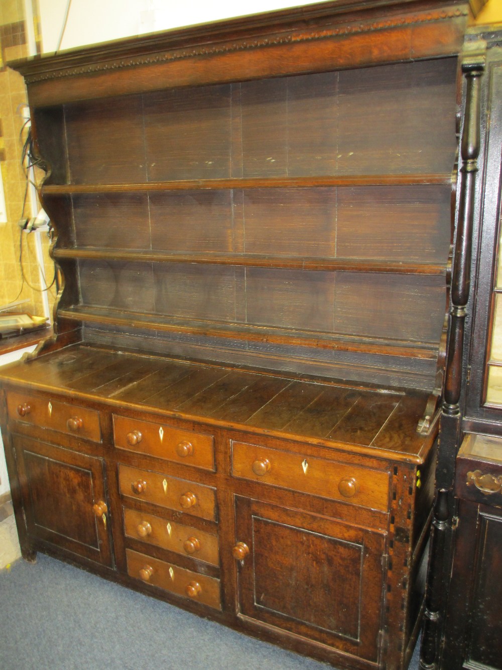 CIRCA 1820 WELSH OAK DRESSER the three shelf shape sided rack having wide back boards over a multi