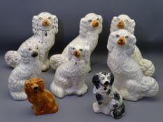 STAFFORDSHIRE POTTERY SEATED SPANIELS, a mixed group of eight