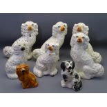 STAFFORDSHIRE POTTERY SEATED SPANIELS, a mixed group of eight