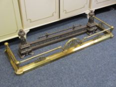 TWO VICTORIAN/STYLE FIRE FENDERS including a brass example with fan detail and ball capped ends,