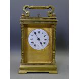 FRENCH BRASS CARRIAGE CLOCK REPEATER retailed by Harrods, London, having a fine gilt mask and