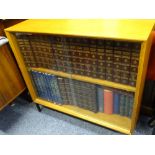 TEAK BOOKCASE containing 25 volume set of The Encyclopaedia Britannica and other books and bound