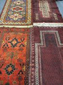 FOUR PERSIAN/MIDDLE EASTERN WOOLLEN CARPETS, three various tonal red ground with multi-bordered