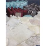 INTERIOR FURNISHINGS PARCEL including four sheepskin rugs, stylish and colourful scatter cushions