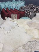 INTERIOR FURNISHINGS PARCEL including four sheepskin rugs, stylish and colourful scatter cushions