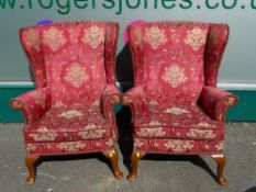 VINTAGE PARKER KNOLL WING-BACK ARMCHAIRS, a pair in wine colour upholstery with floral embossed