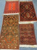 FOUR EASTERN/PERSIAN STYLE SCATTER RUGS, all red ground with traditional repeating block patterns