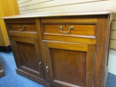 LATE VICTORIAN MAHOGANY BASE CUPBOARD of two drawers and two lower cupboard doors on a plinth