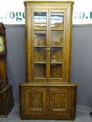 ANTIQUE SCUMBLED PINE TWO PIECE CORNER CUPBOARD having a shaped cornice over twin four panel