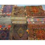 THREE MIDDLE EASTERN/PERSIAN TYPE CARPET CAMEL BAGS in mixed colours, in traditional bordered