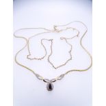 TWO 9CT GOLD NECKLACES including a fine link example, 45cms L and a flat link necklace with two tone