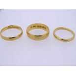 THREE 22CT GOLD WEDDING BANDS, ring size H (misshapen), M and mid K-L, 10grms gross