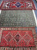 THREE IRANIAN, PERSIAN/MIDDLE EASTERN STYLE CARPETS including a green ground example with