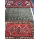 THREE IRANIAN, PERSIAN/MIDDLE EASTERN STYLE CARPETS including a green ground example with