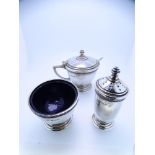 SILVER THREE PIECE CONDIMENT SET, Birmingham 1935, consisting open salt with blue glass liner,