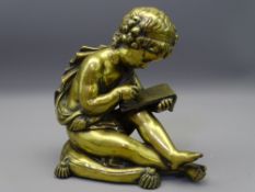 ORNAMENTAL FIGURINE OF A YOUNG SCRIBE in cast brass/polished bronze depicting a young boy seated