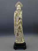 JAPANESE IVORY OKIMONO MEIJI PERIOD depicted as a standing man with flag and sword at his side,
