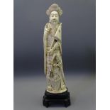 JAPANESE IVORY OKIMONO MEIJI PERIOD depicted as a standing man with flag and sword at his side,