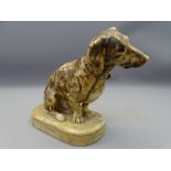 VINTAGE CARVED ALABASTER DACHSHUND seated with attentive pose on an oval base, signed 'M