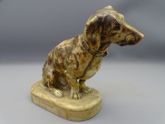 VINTAGE CARVED ALABASTER DACHSHUND seated with attentive pose on an oval base, signed 'M