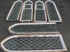 SIX ARCHED TOP STAIN GLASS & LEADED WINDOW FRAMES, three having red edging, three blue, 181cms H,