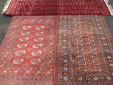 THREE PERSIAN/EASTERN WOVEN SILK & WOOLLEN CARPETS, various red grounds with similar repeat block