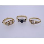 THREE 18CT GOLD DRESS RINGS to include a diamond set example with openwork flower head and leaf